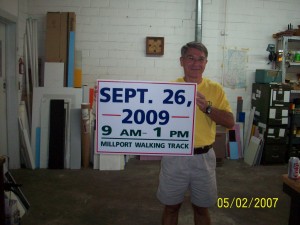 Don displaying a sign donated by Bishop Sign Co.